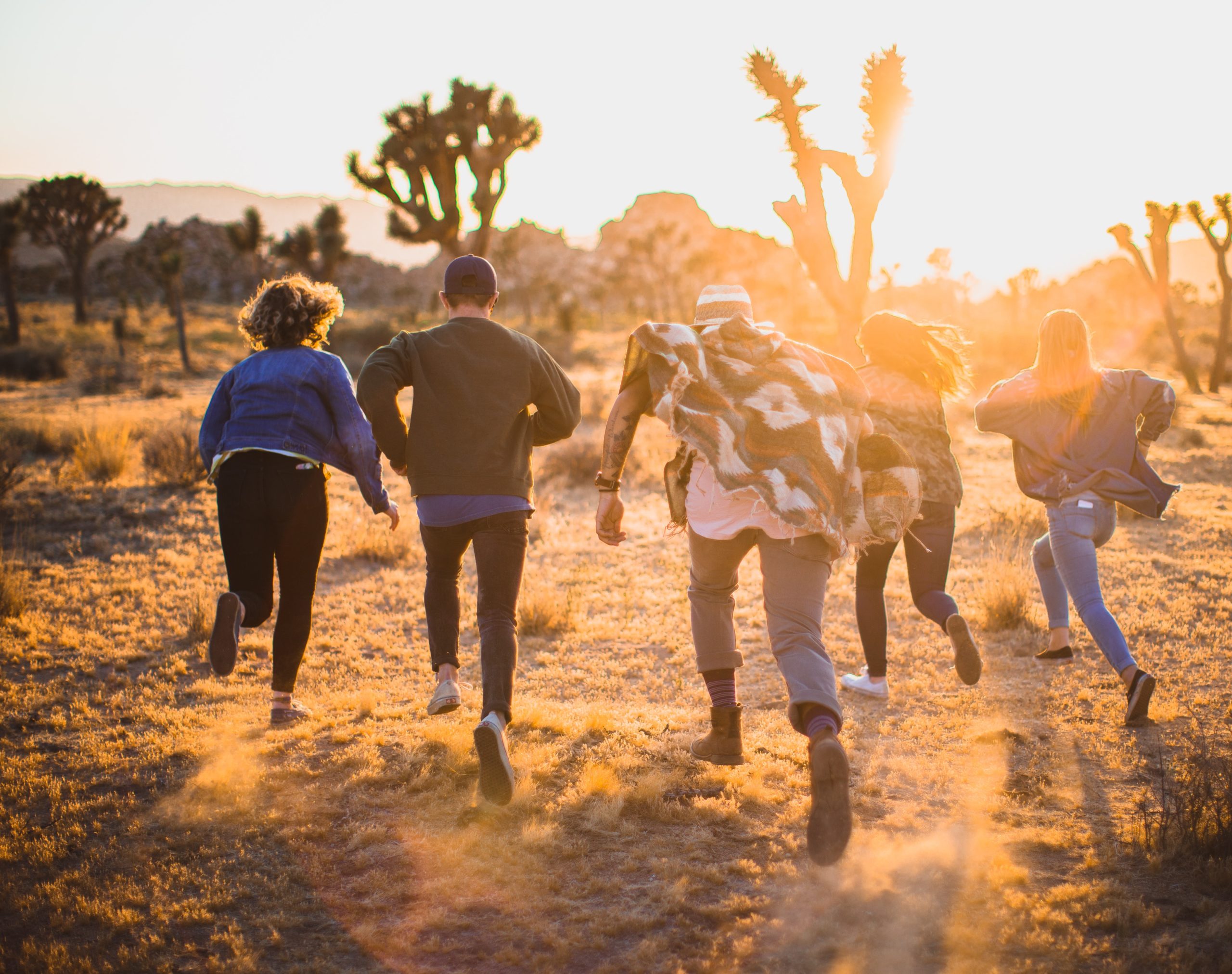 Young people running towardssunlight